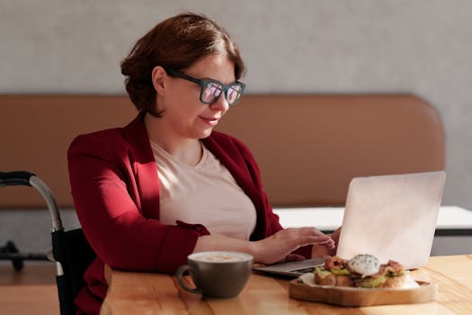 a digital nomad working on a laptop in a coffee shop