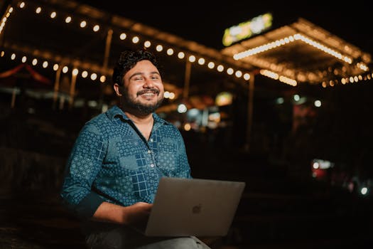 travelers working on laptops at a festival